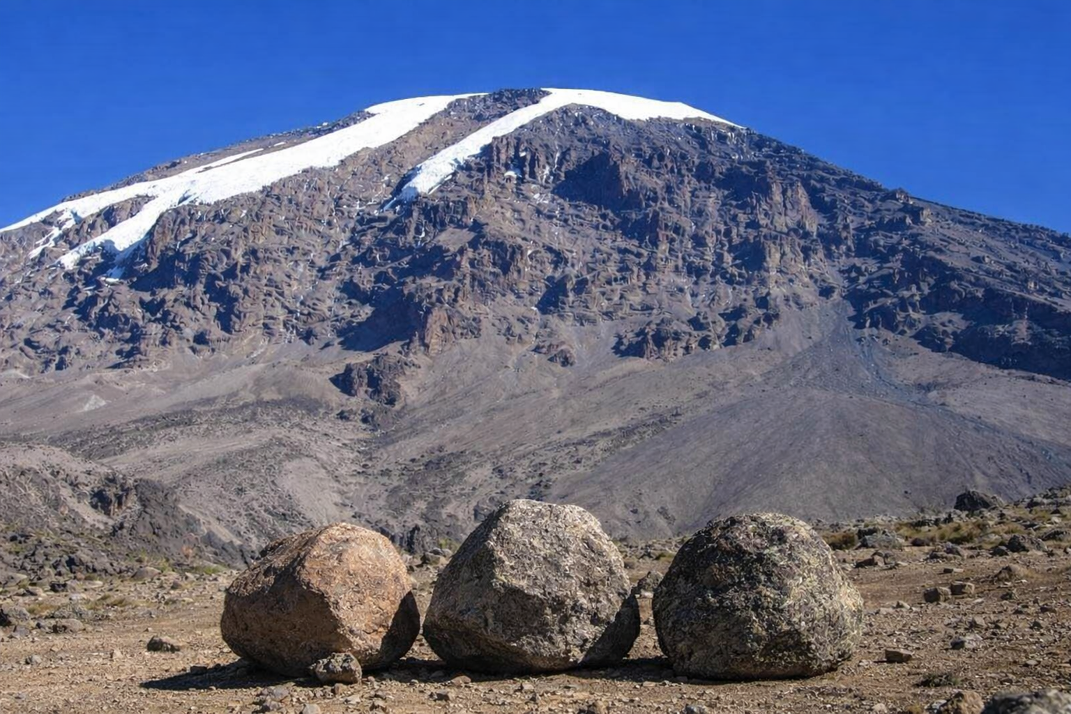 Three rocks at the base of Mount Kilimanjaro, symbolizing resilience and foundation